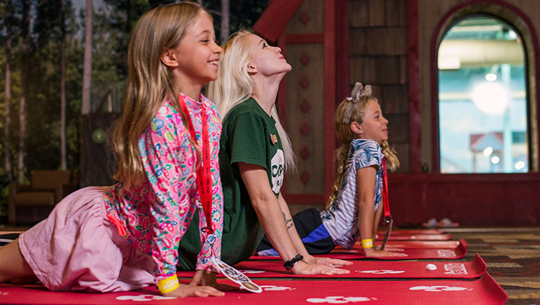 kids doing yoga on red mat